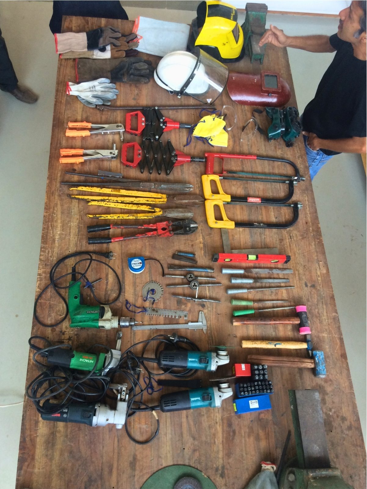 The bench. Every tool laid out and counted before the first cut. The studio began with an inventory, not a site.