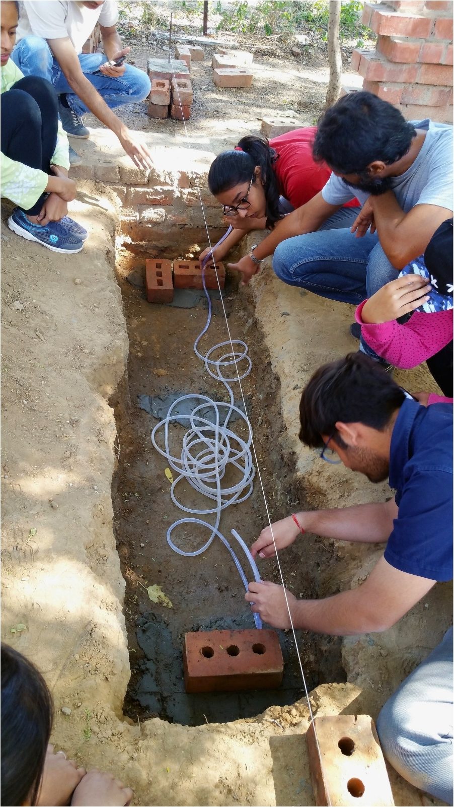 Rebar and the first bricks in the trench. Concrete meets brick at the footing.