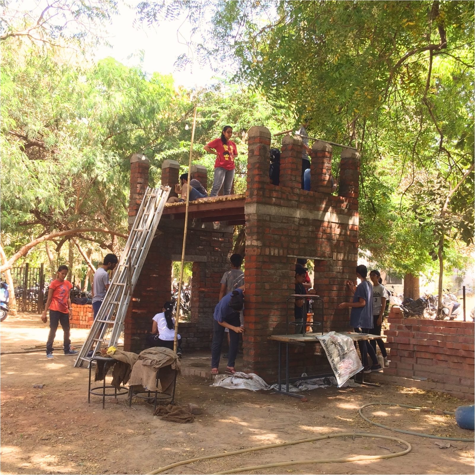 Brick walls rising inside the scaffold. The wall head where brick would have to meet bamboo.