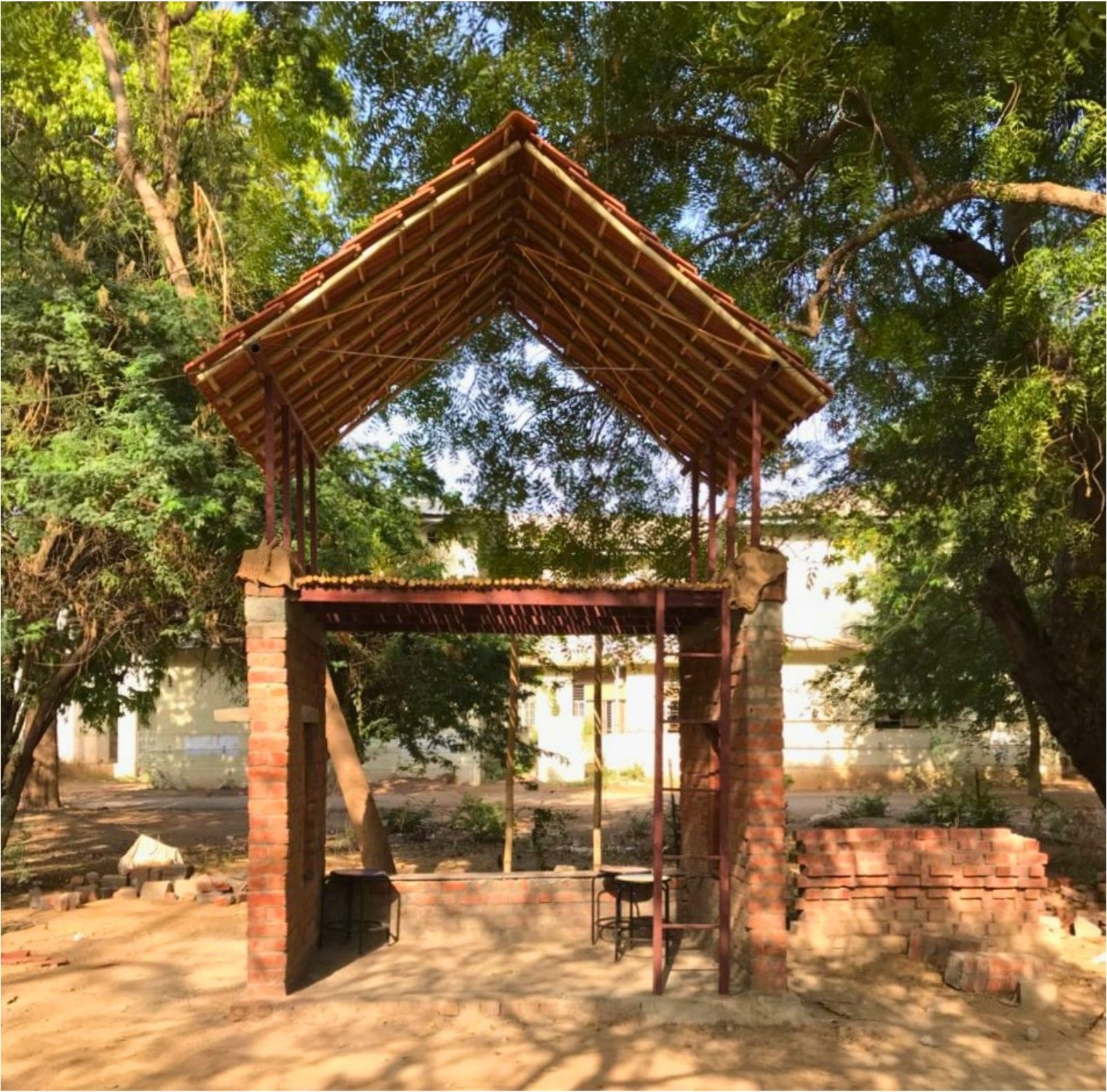 The second structure. Brick plinth, bamboo gable roof.