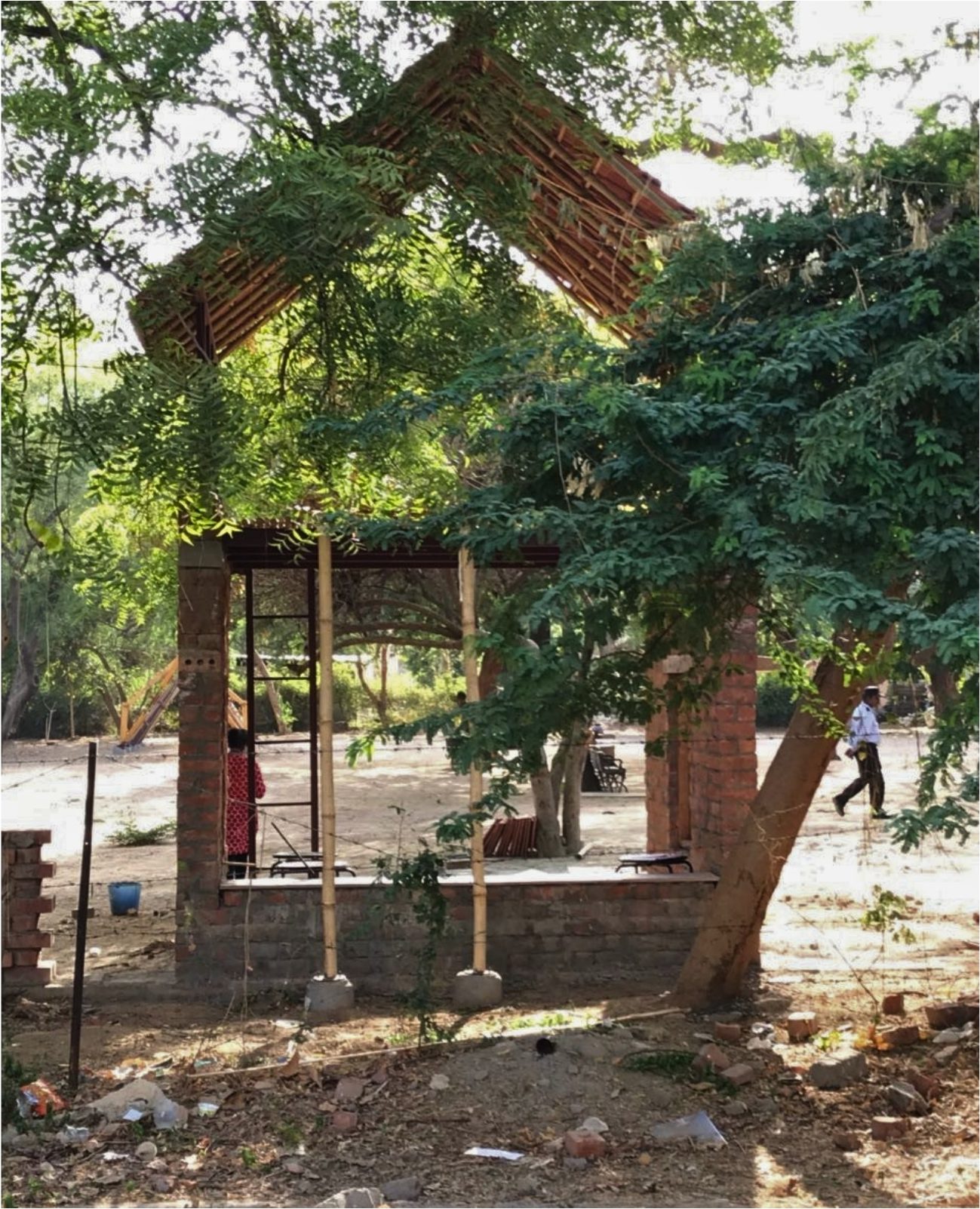 The same structure under construction. Bamboo posts on the plinth, before the roof.