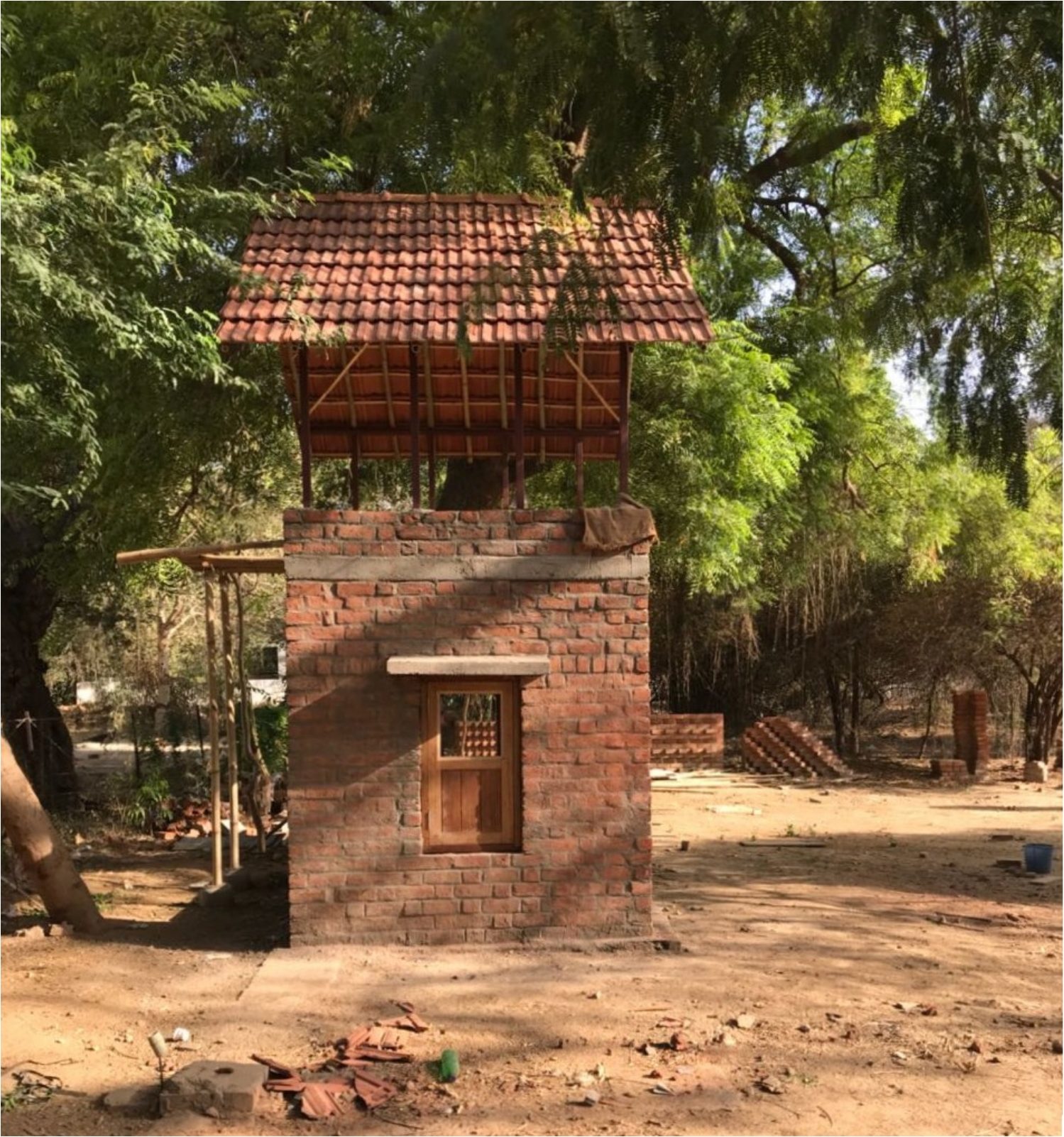 The tower, finished. Tile roof, timber window, brick to the sill. Compare fig.01.
