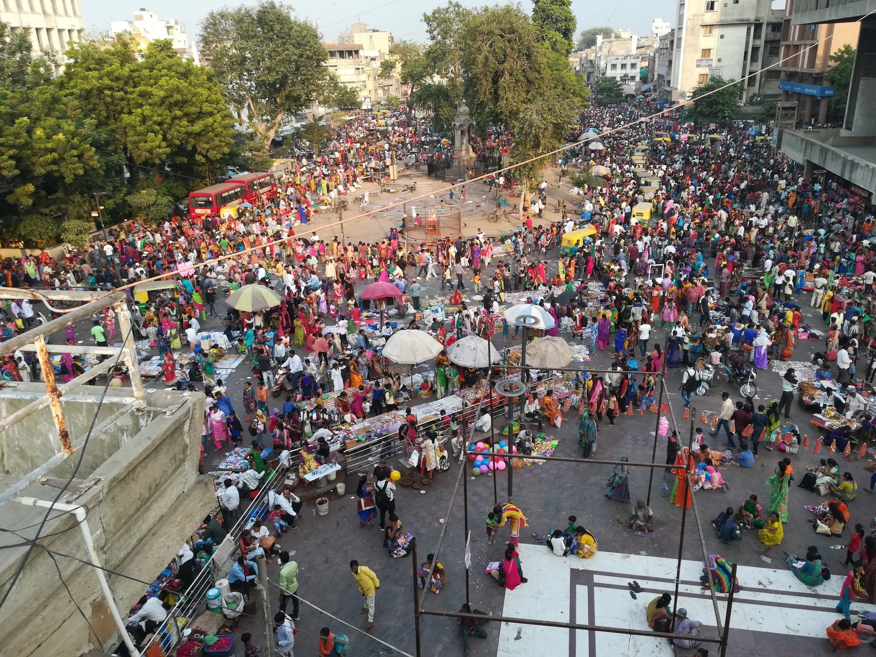 The plaza as fairground. The market crowd seen from above. The inserts borrow this character, one edge at a time.