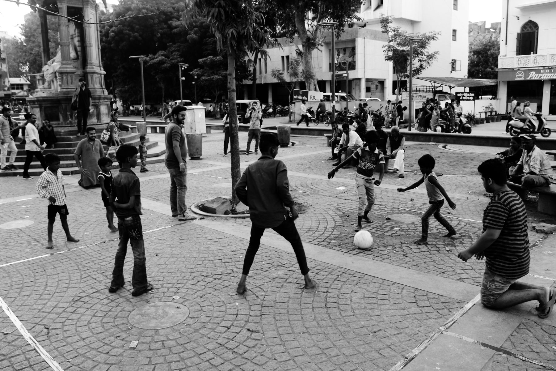 The performance. A boundary marked on the plaza floor, a ball, and within minutes the kids of the plaza playing inside it.