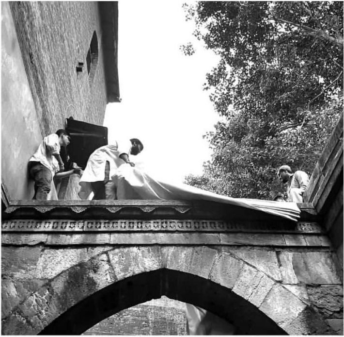 The sheet goes over the arch. Three of us on the parapet, the cloth dropped and pulled square from below.